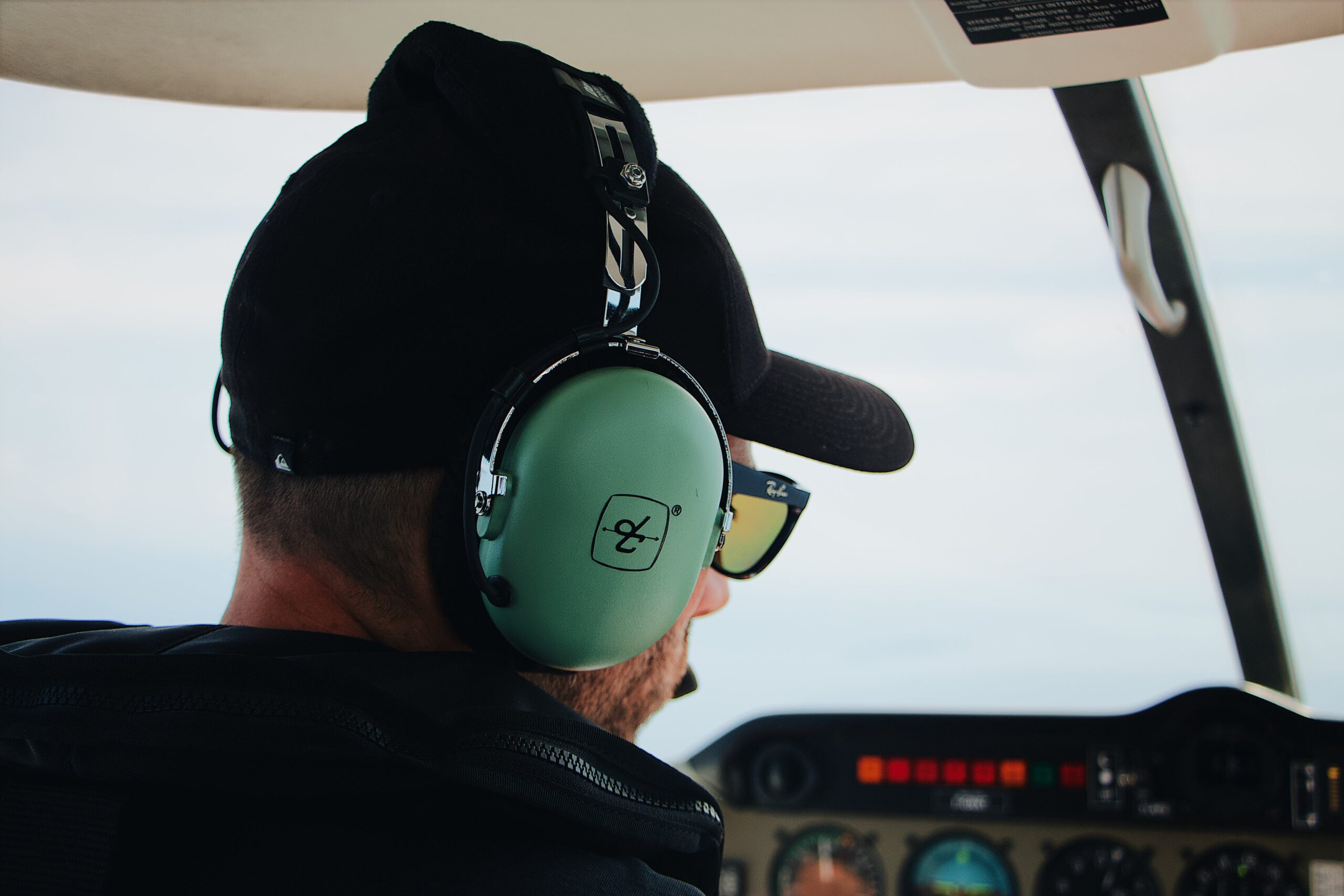 A pilot wears a David Clark headset in an airplane