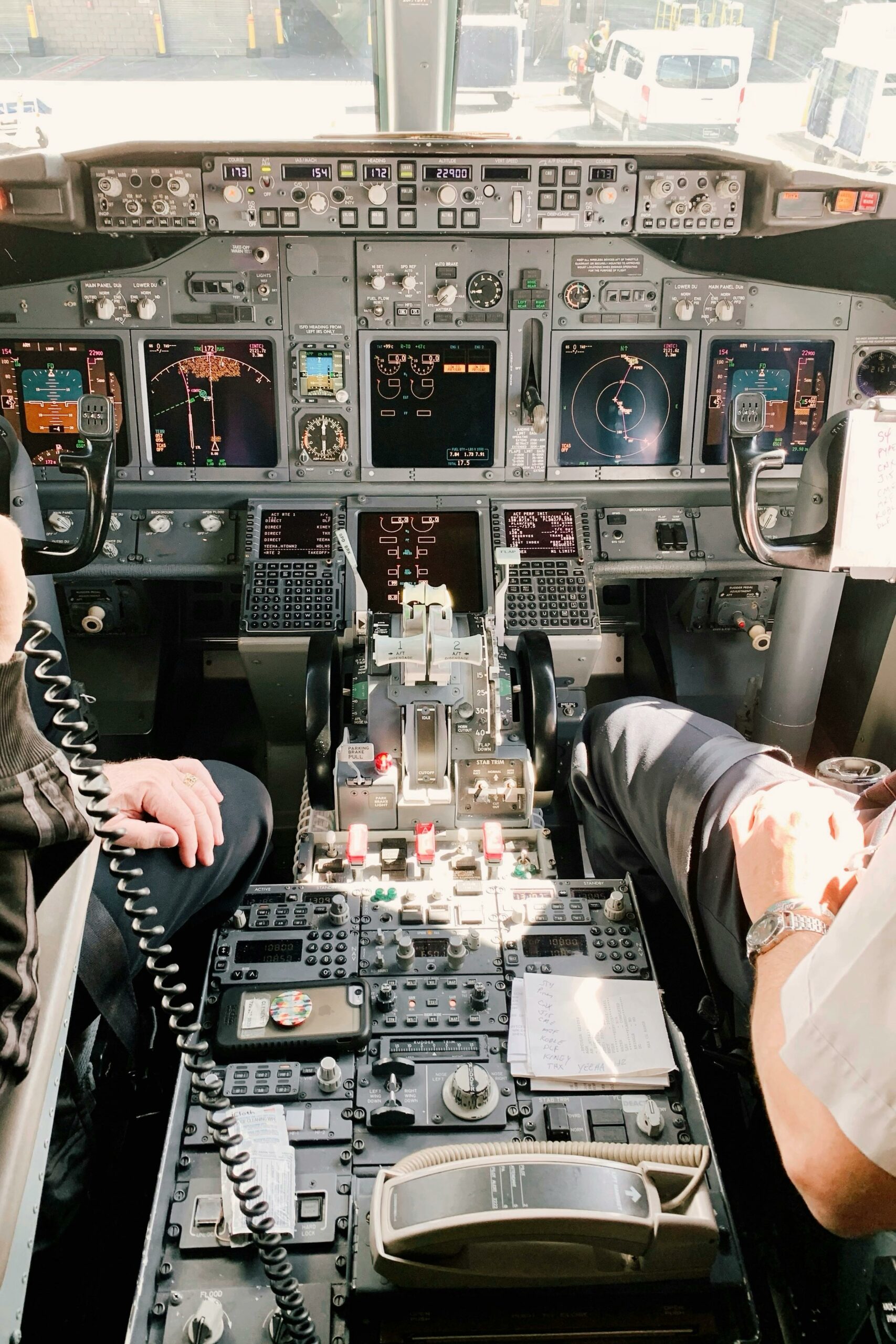 Two pilots sit in the flight deck