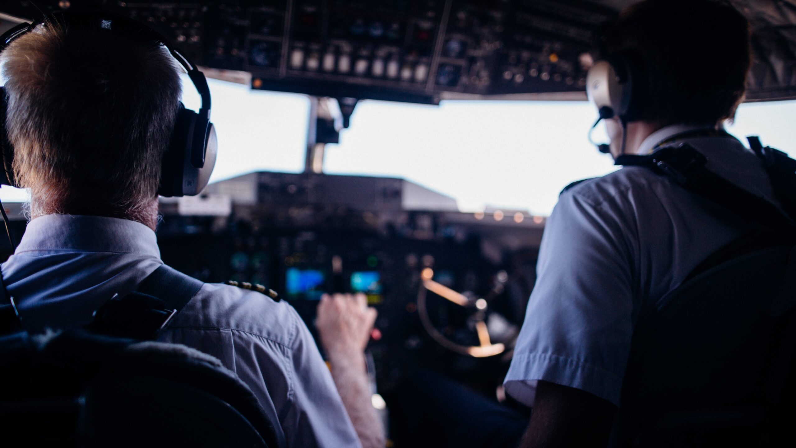 Two pilots in the flight deck focus on flying